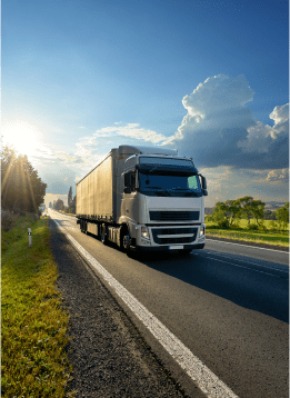 Truck driving in the countryside with blue sky